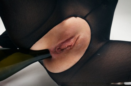 Fetish girl Areana Fox in crotchless catsuit stuffs a wine bottle in her twat 42058208
