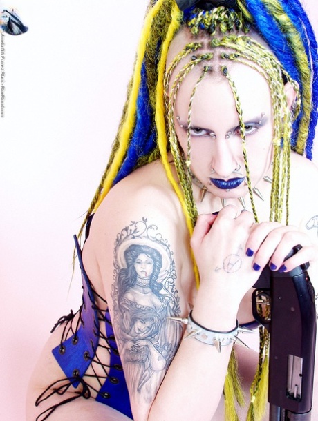 Alternative model Jenner Christ plays with a gun while wearing a corset 49689416