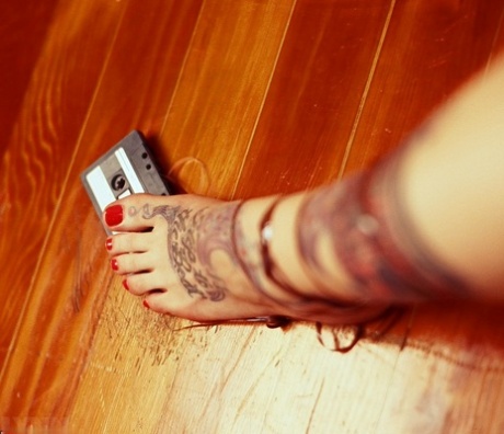 Tatted blonde Lynn Pops crushes a cassette tape before licking an frozen treat 23369074
