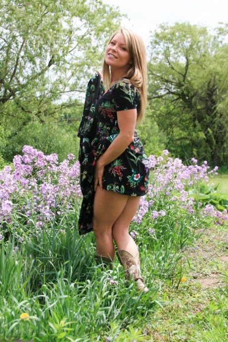 Slutty blonde MILF Madden sheds her long dress in a field to pose in a thong 78509006