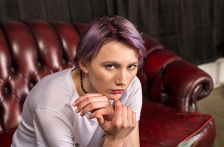 Naked female with dyed hair sports a ball gag while hogtied on a coffee table 18920540