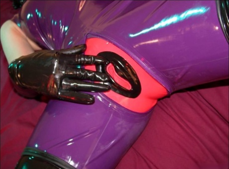 Solo model inserts a dildo while wearing head to toe latex clothing 10688768