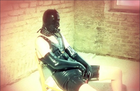 Blonde woman masturbates on a wooden chair while wearing fetish apparel 45641870