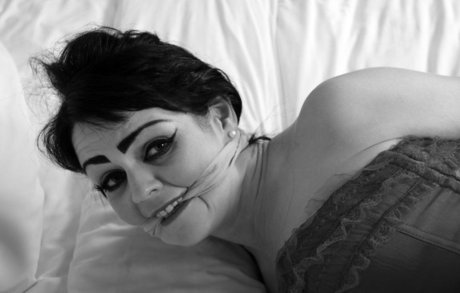 Dark haired MILF gets tied up on a bed in a pretty red dress and red heels 51656270