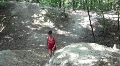 Blonde girl Licky Lex takes a pee over a fallen tree while in the woods 51070353