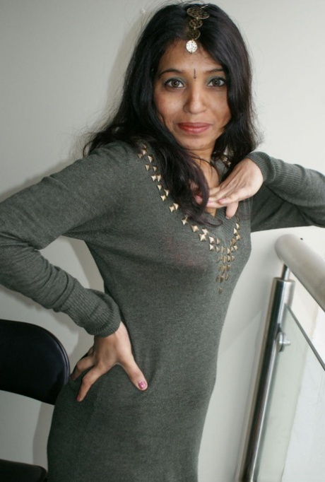 Indian lady Kavya Sharma sits on a cushion after removing clothes and boots 56451453