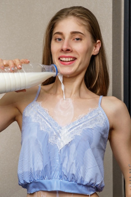 Slender brunette Amelinda pours a litre of milk over small tits and bald twat 27055561