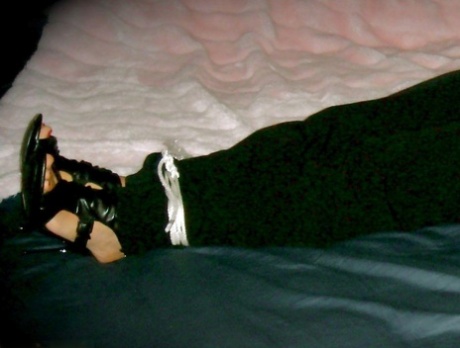 Caucasian woman is spied upon after being left bound and gagged upon a bed 53278931