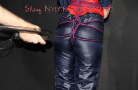 Caucasian girl is restrained in a nylon rain suit before being gagged 48671944