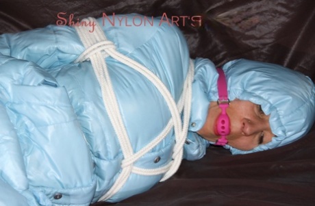 White girl is fitted with a ball gag while tied up in an down winter coat 59433280