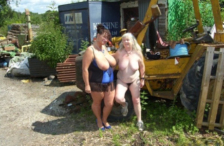 Thick older ladies Busty Kim and April have a threesome amid farm equipment 68901004