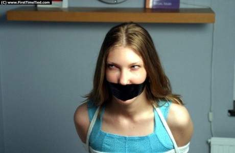 Blonde in black miniskirt has her mouth duct taped shut after being rope bound 74619251