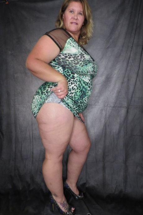 Obese amateur Busty Kris Ann takes of a dress and thong to model naked 89250309