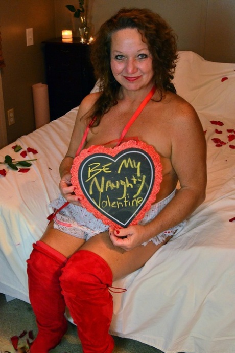 Mature woman Debbie Delicious displays her saggy tits in over the knee boots 85711245