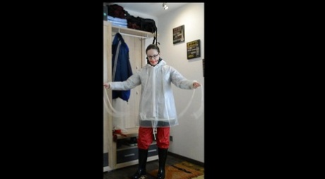 Solo woman Lady Nadja layers herself in rainwear during self bondage action 41364673