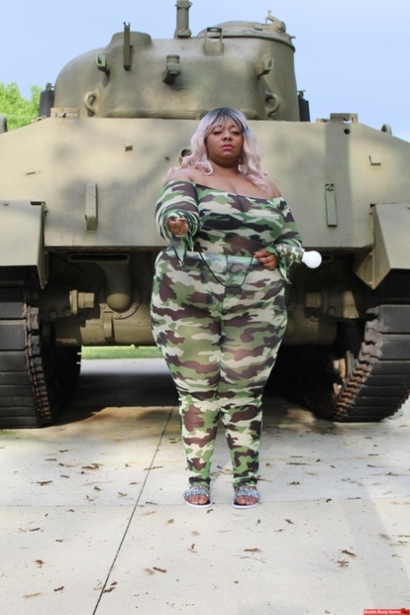 Obese black woman Carmelotto Rush shows her thong clad butt afore a tank 45015250