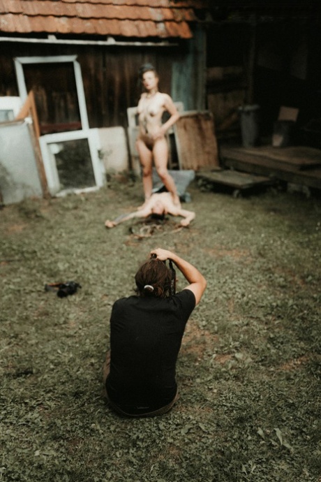 Heavily tattooed girls piss on a naked man outside the back steps of a house 59105543