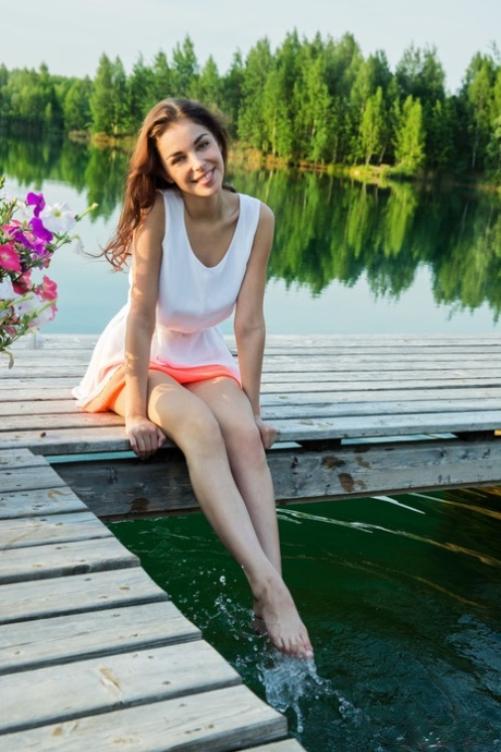 Beautiful teen Evita Lima shows her natural tits and nice legs while on a dock 13784281
