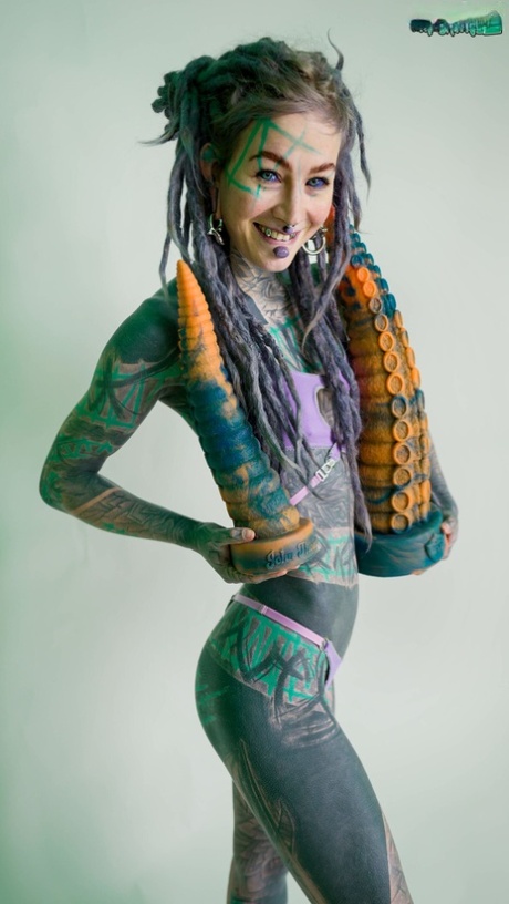 Heavily tattooed girl Anuskatzz holds a couple of taintacle toys in the nude 61932882