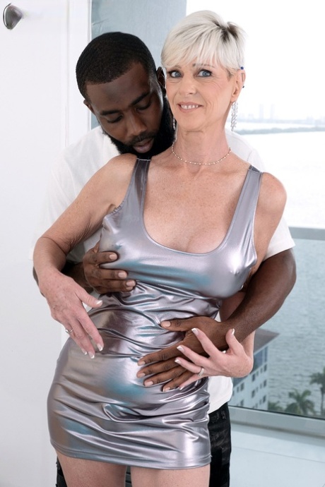 Older platinum blonde Foxxxy Darlin has interracial sex with a younger man 62694593