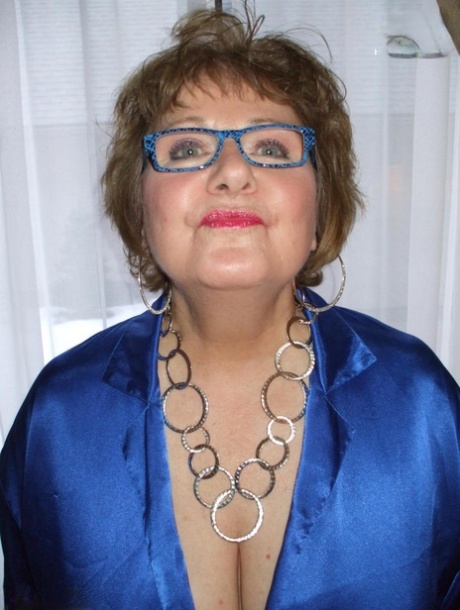 Older lady Busty Bliss displays her big natural tits while wearing glasses 99931373