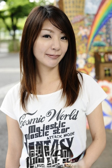 Japanese solo girl Tomomi Matsuda poses outdoors in a T-shirt and denim shorts 25650451