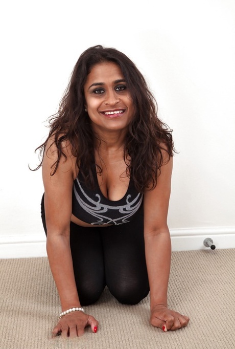Dirty-minded mature lassie undressing and exposing her shaggy twat 82392573