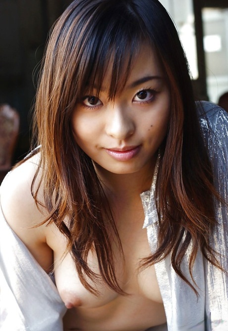 Petite asian babe Hikaru Koto taking off her shirt and posing topless 95909212